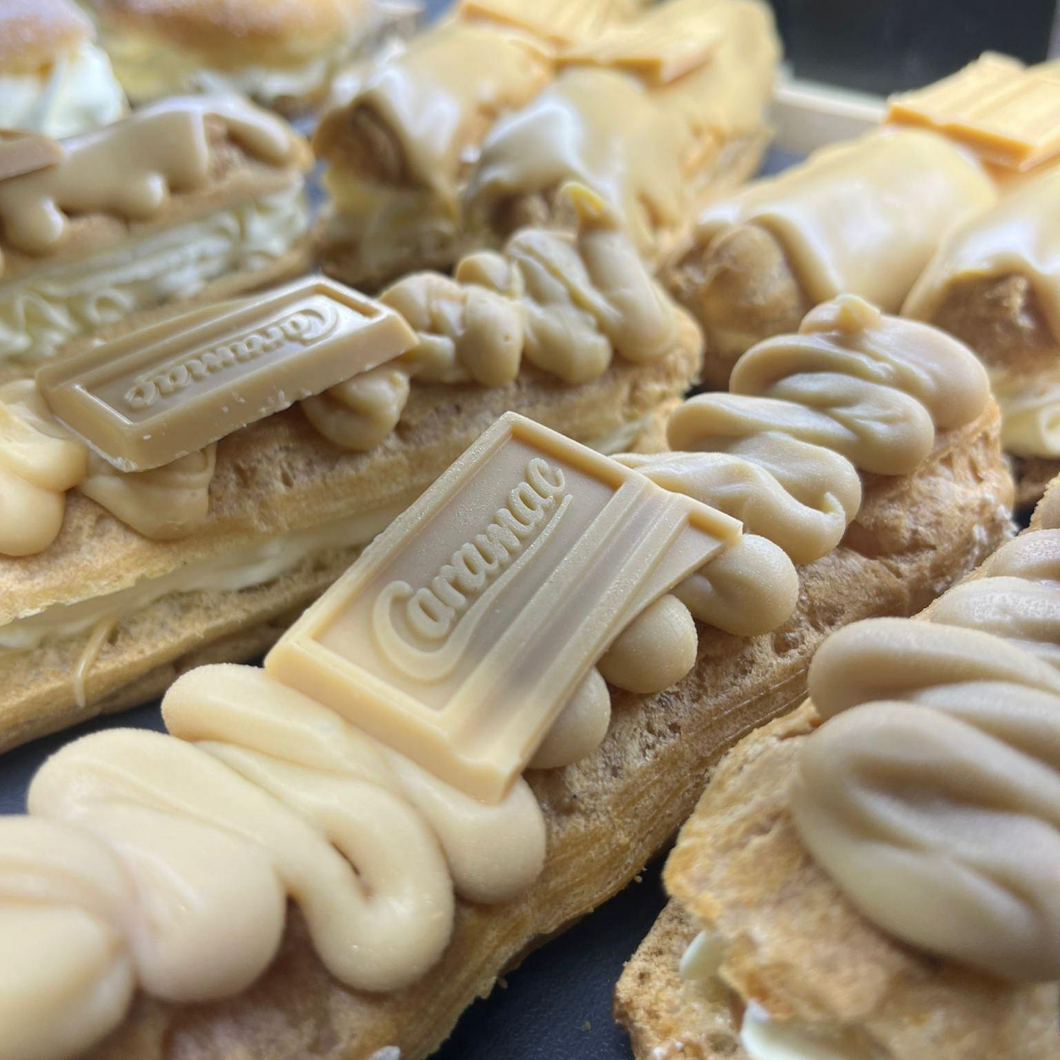 Caramac eclairs in a bakery display shelf