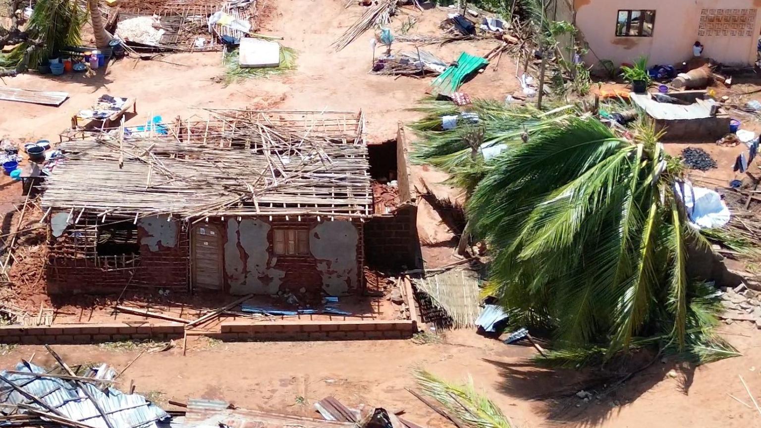 An aerial shot shows partially destroyed buildings and uprooted trees in Mozambique's Cabo Delgado province.