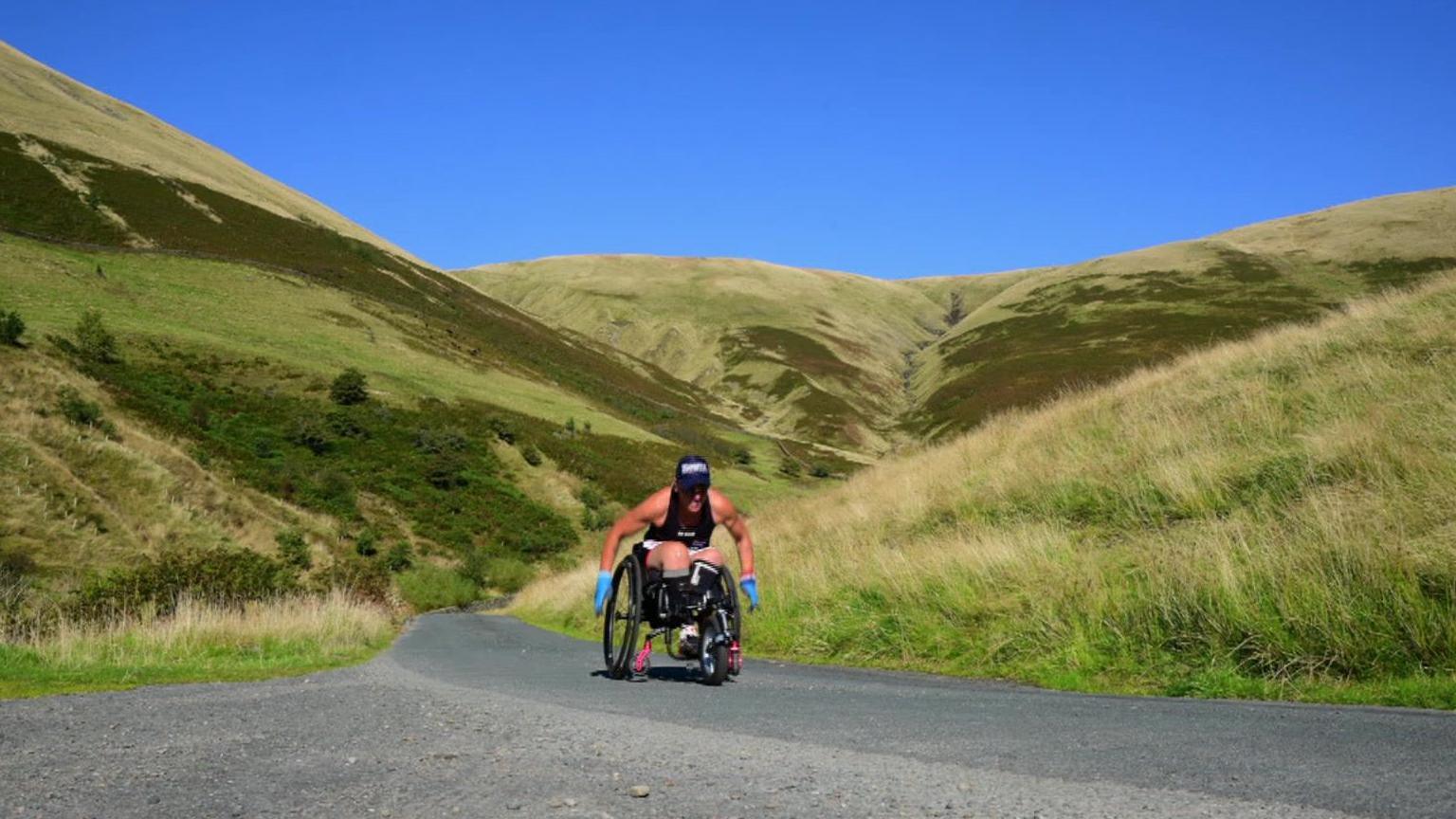 Lexi in her wheelchair, travelling through Devon countryside