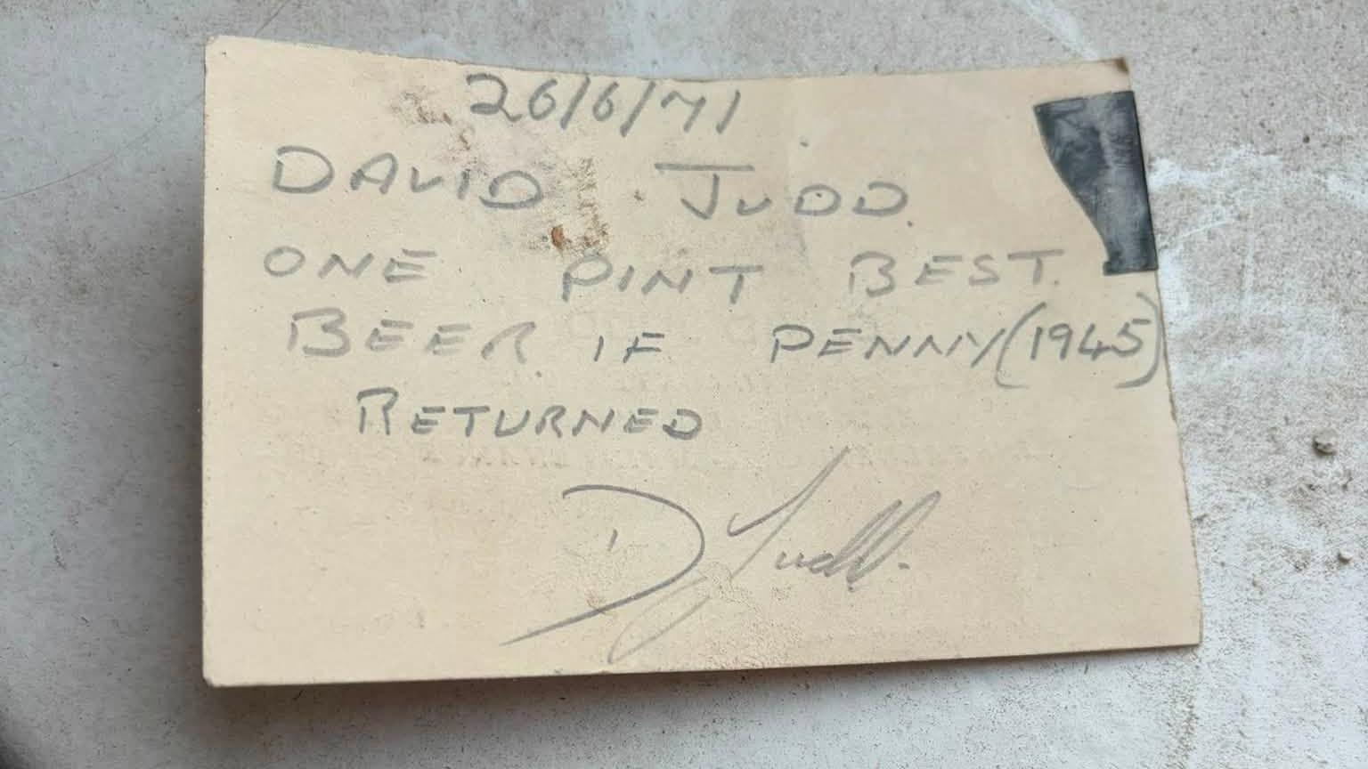 A message on a card is signed "D Judd" and reads "26/6/71. David Judd. One pint best beer if penny (1945) returned."