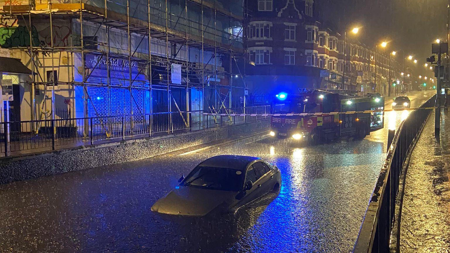 A car partly submerged in floodwater on Manor Road in Wallington