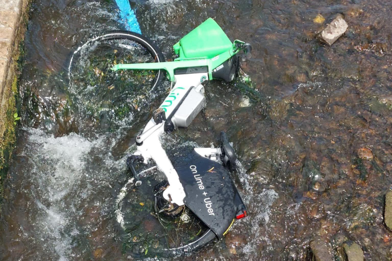 A Lime bike in a shallow part of the River Leen in Nottingham