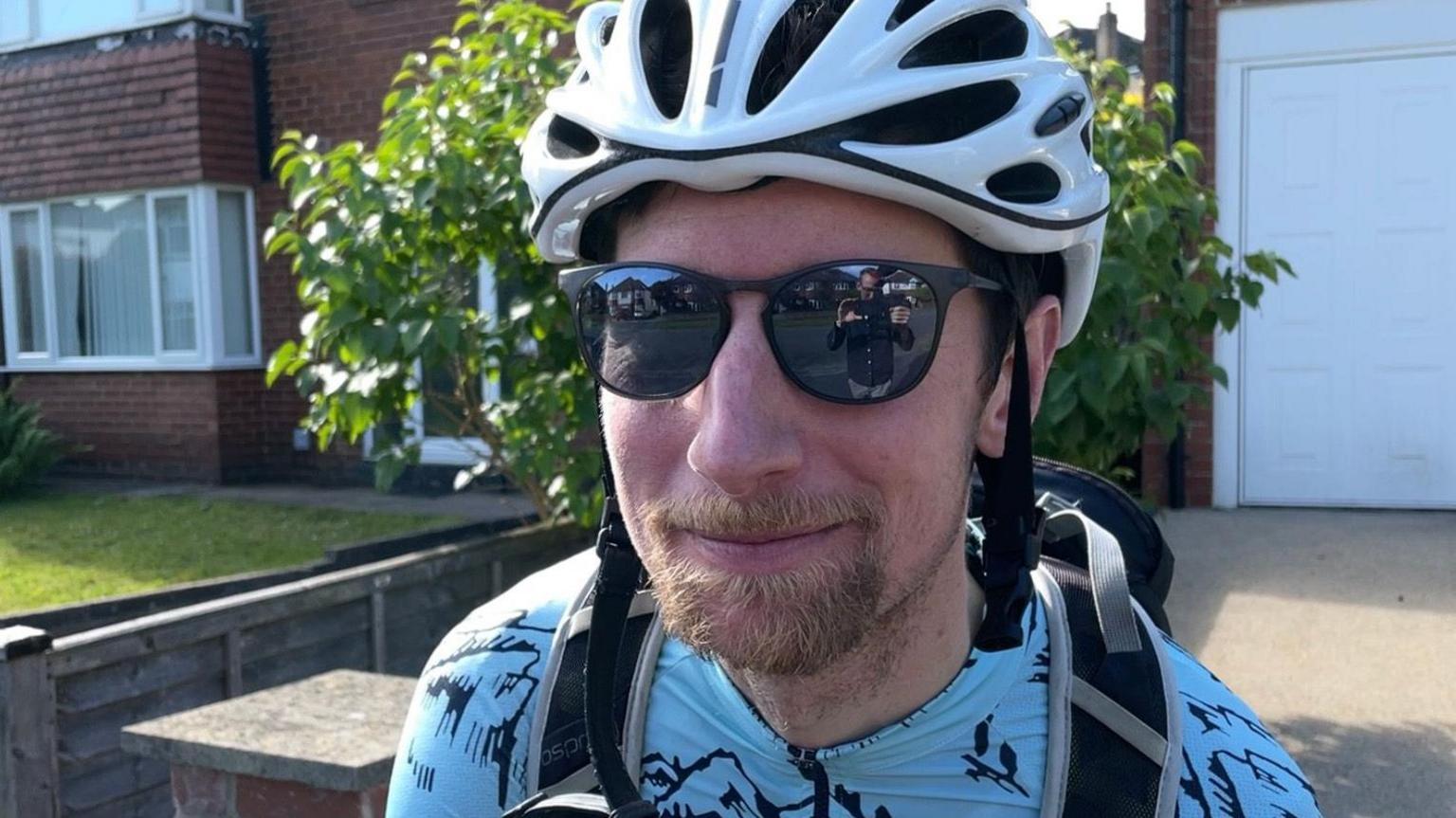 Ben Hall wearing cycle helmet and sunglasses