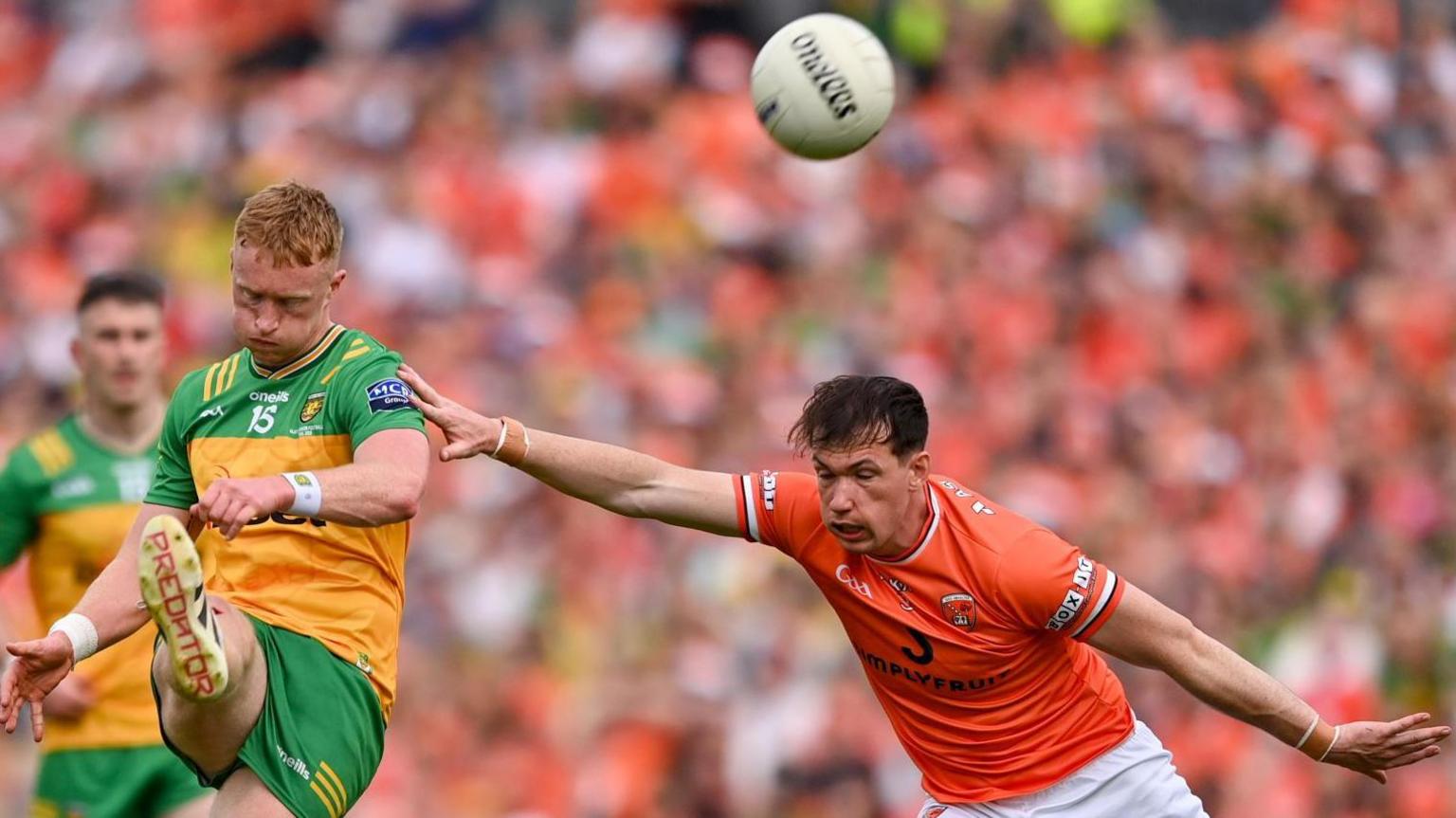 Donegal's Oisin Gallen gets in a shot despite the efforts of Armagh defender Barry McCambridge