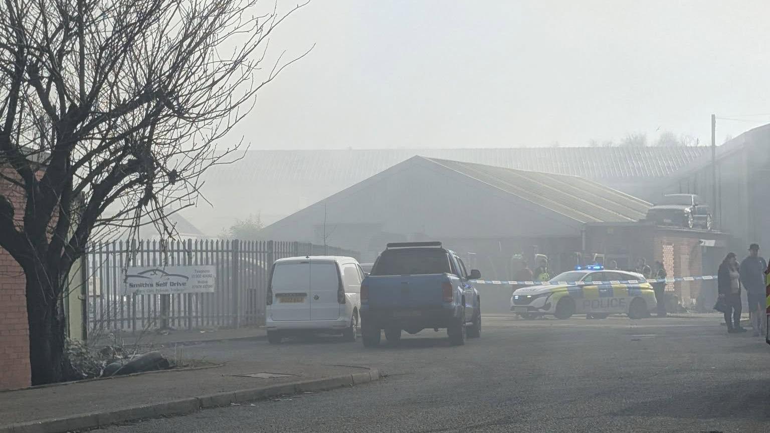 A police car at the entrance of an industrial estate in Wolverhampton