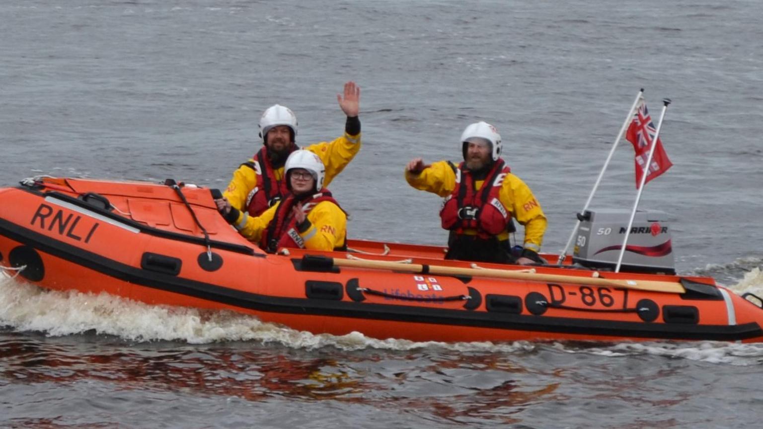 Lifeboat volunteers wave