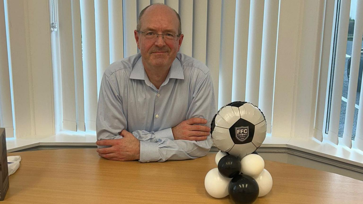 Michael Murray of Fraserburgh sits at a desk