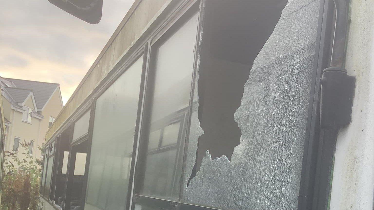 A smashed window of a coach 