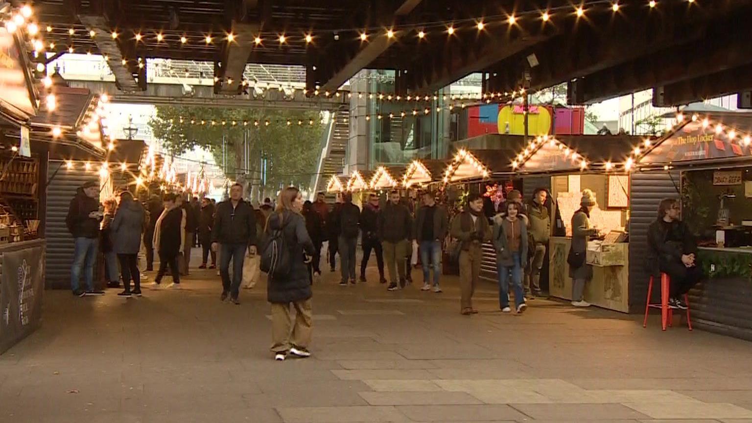 Southbank winter market chalets with lights and people browsing 