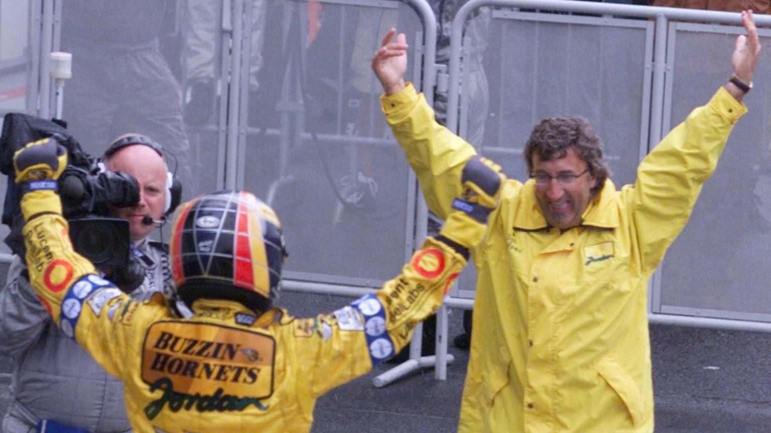 Jordan and driver Heinz-Harald Frentzen both have arms aloft as the German driver gets out of his car after winning the 1999 French Grand Prix