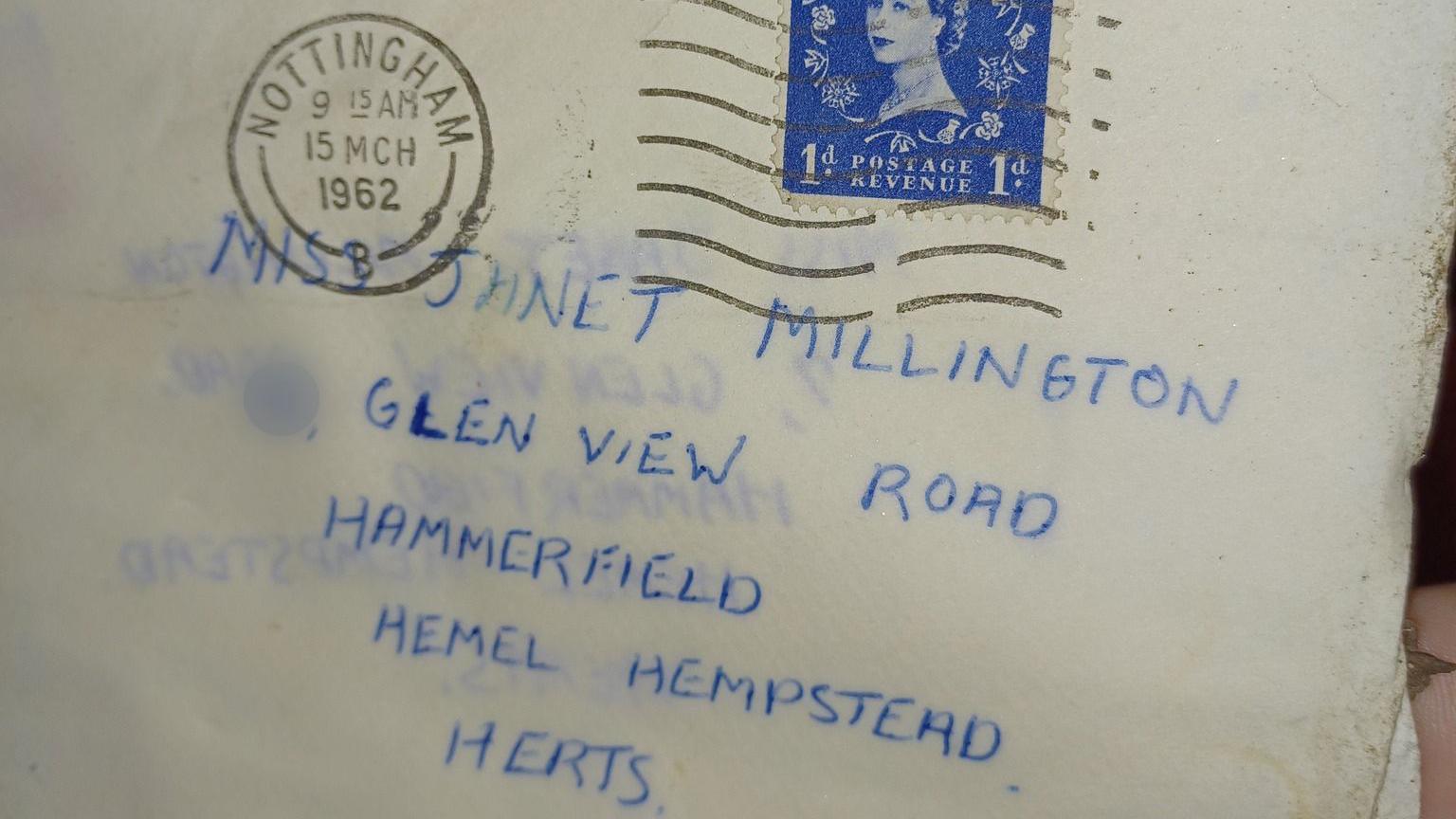 A letter with a Nottingham post stamp dated 15th March 1962. It is addressed in blue ink to a woman in Hemel Hempstead. The stamp is blue and has a picture of Queen Elizabeth II