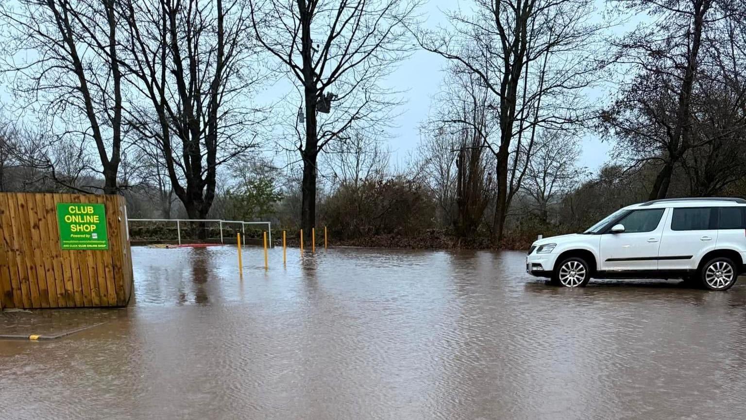 Photograph of white car surrounded by water in the car park at Littleborough Sports Club, 23 November 