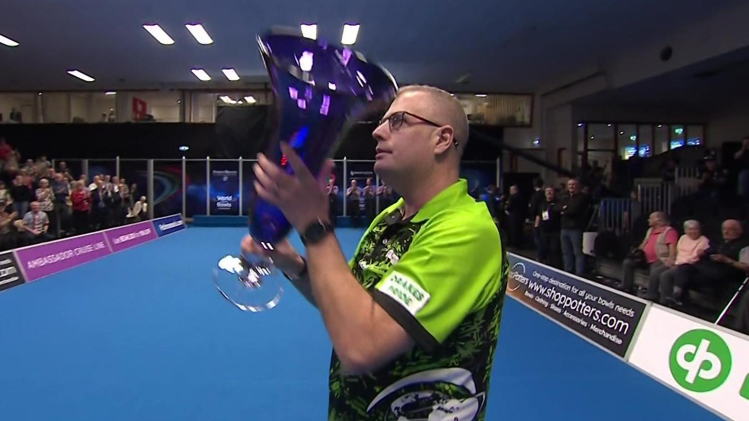 Robert Paxton lifts the World Indoor Bowls Championship trophy