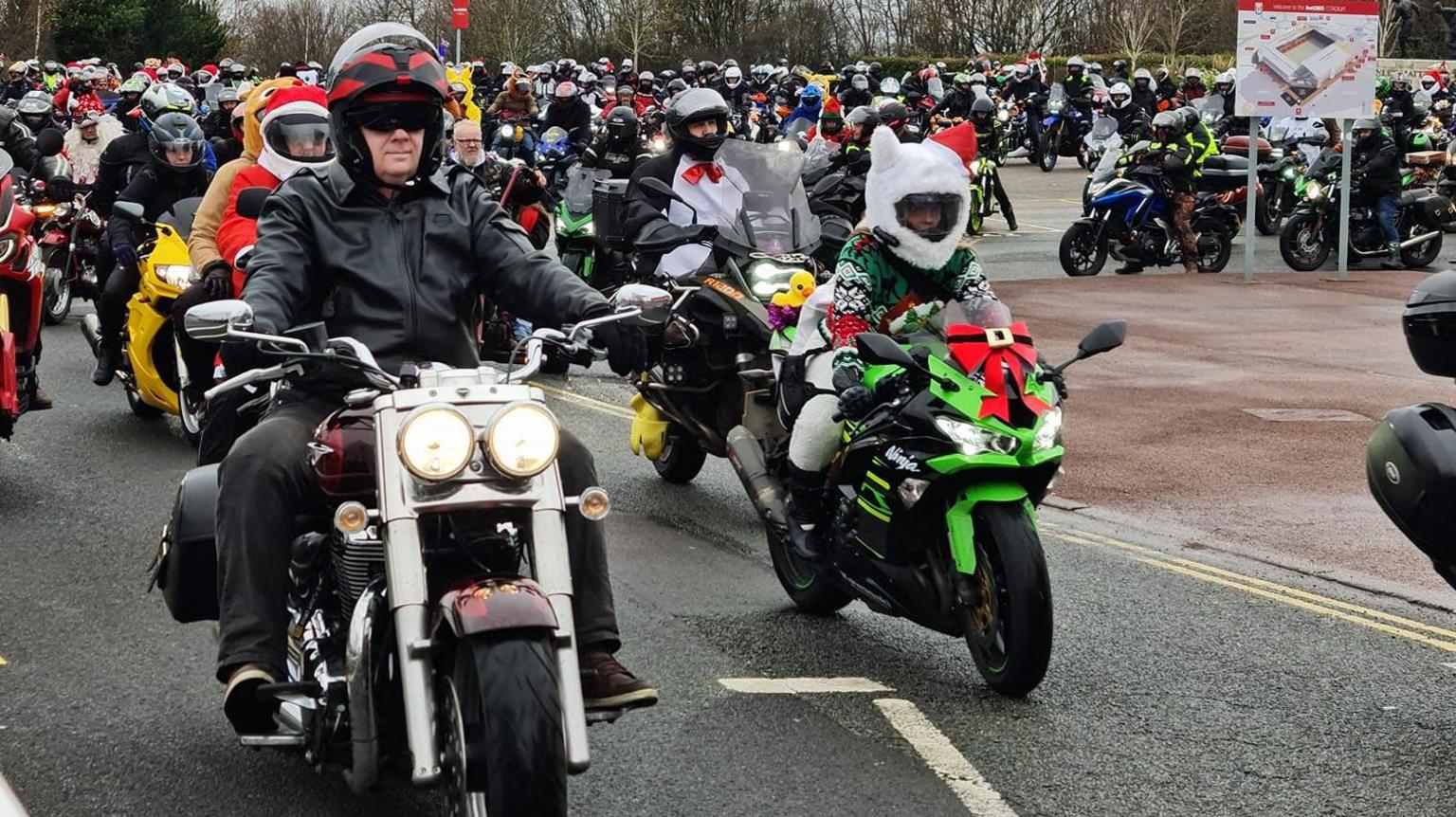 Hundreds of people on motorbikes, wait to start a convoy. 