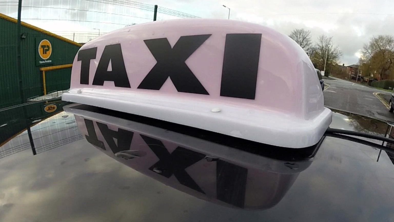 Taxi sign on car