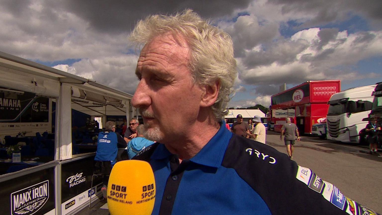 Philip Neill speaks into a BBC Northern Ireland microphone