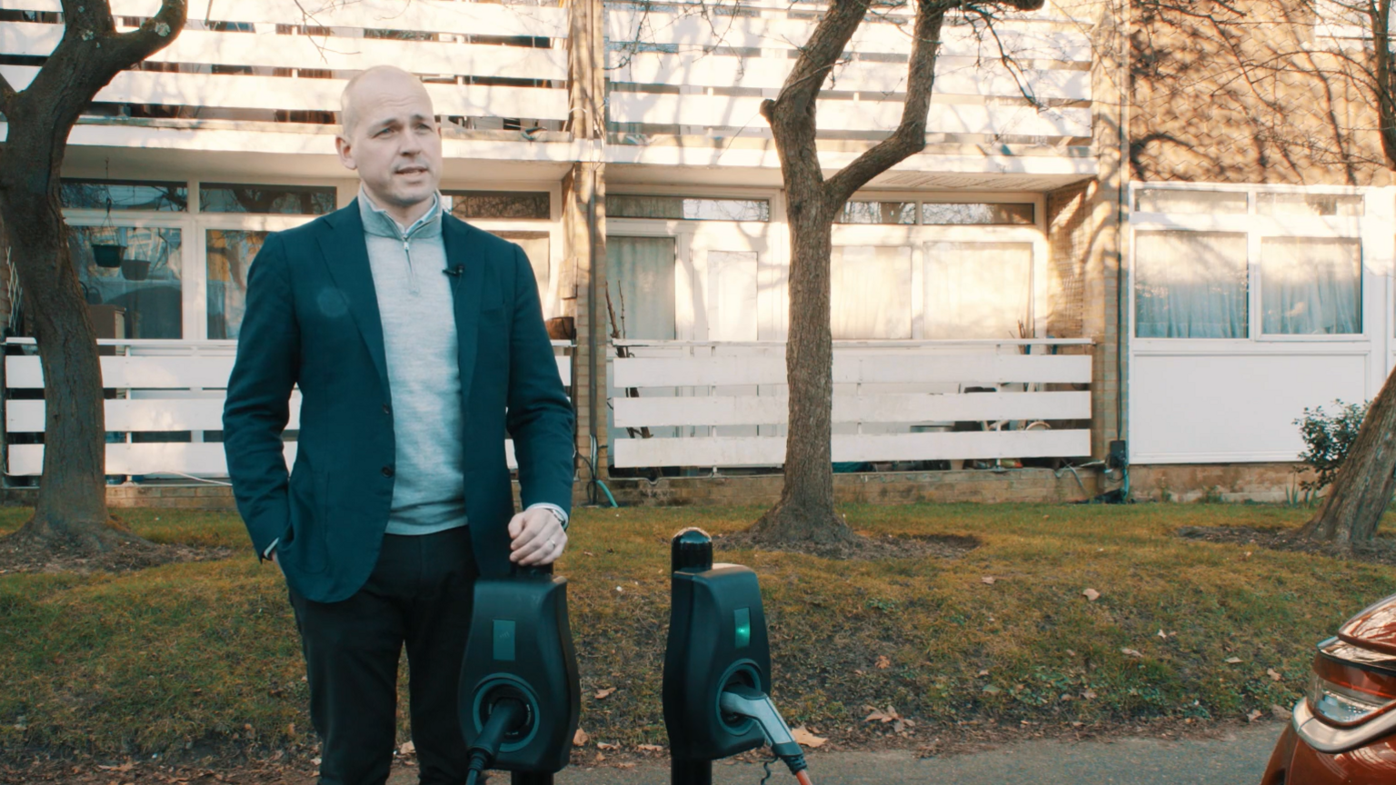 Chris Pateman-Jones, chief executive of Connected Kerb, stands next to an EV charge point