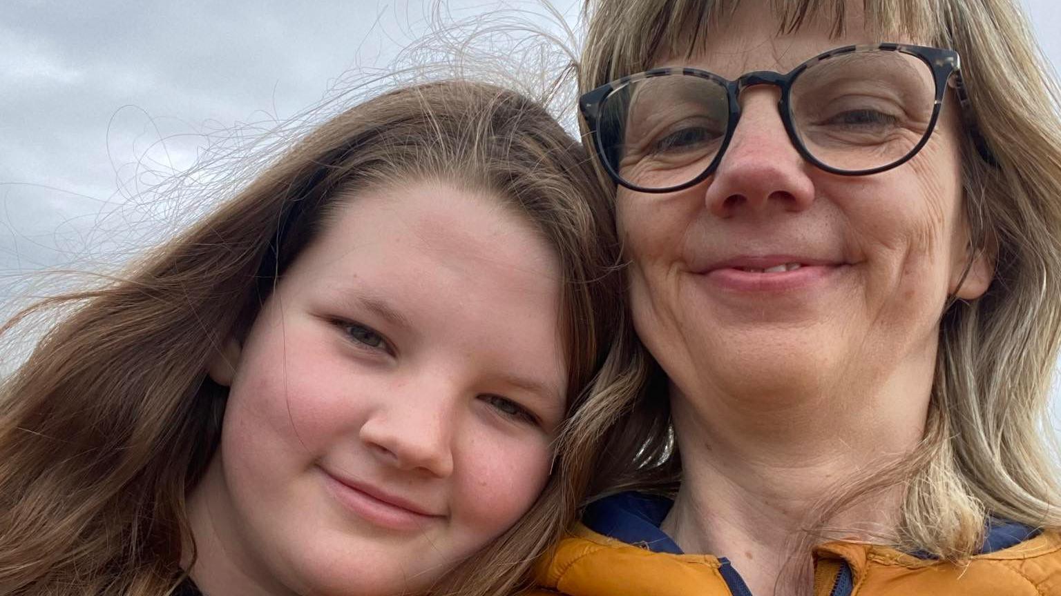 Eliana is pictured smiling with her mum Catherine in a selfie