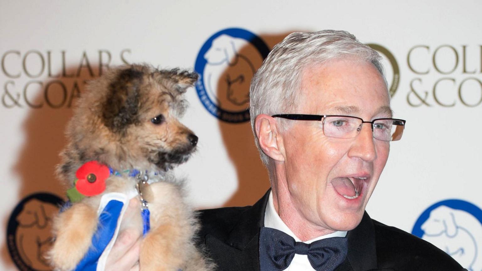 Paul O'Grady (right) holding a dog