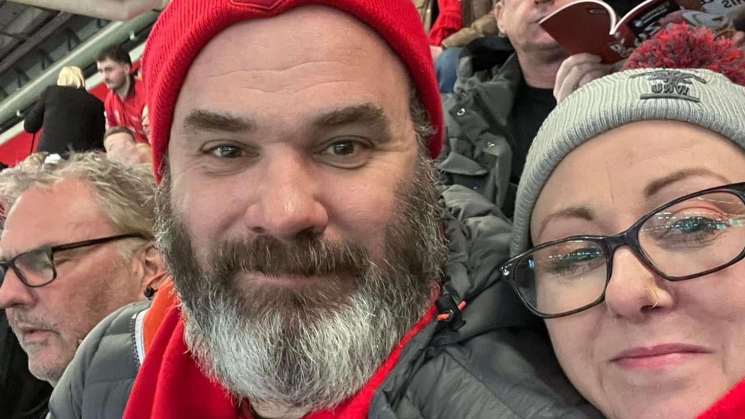 Selfie of a man and woman at rugby match