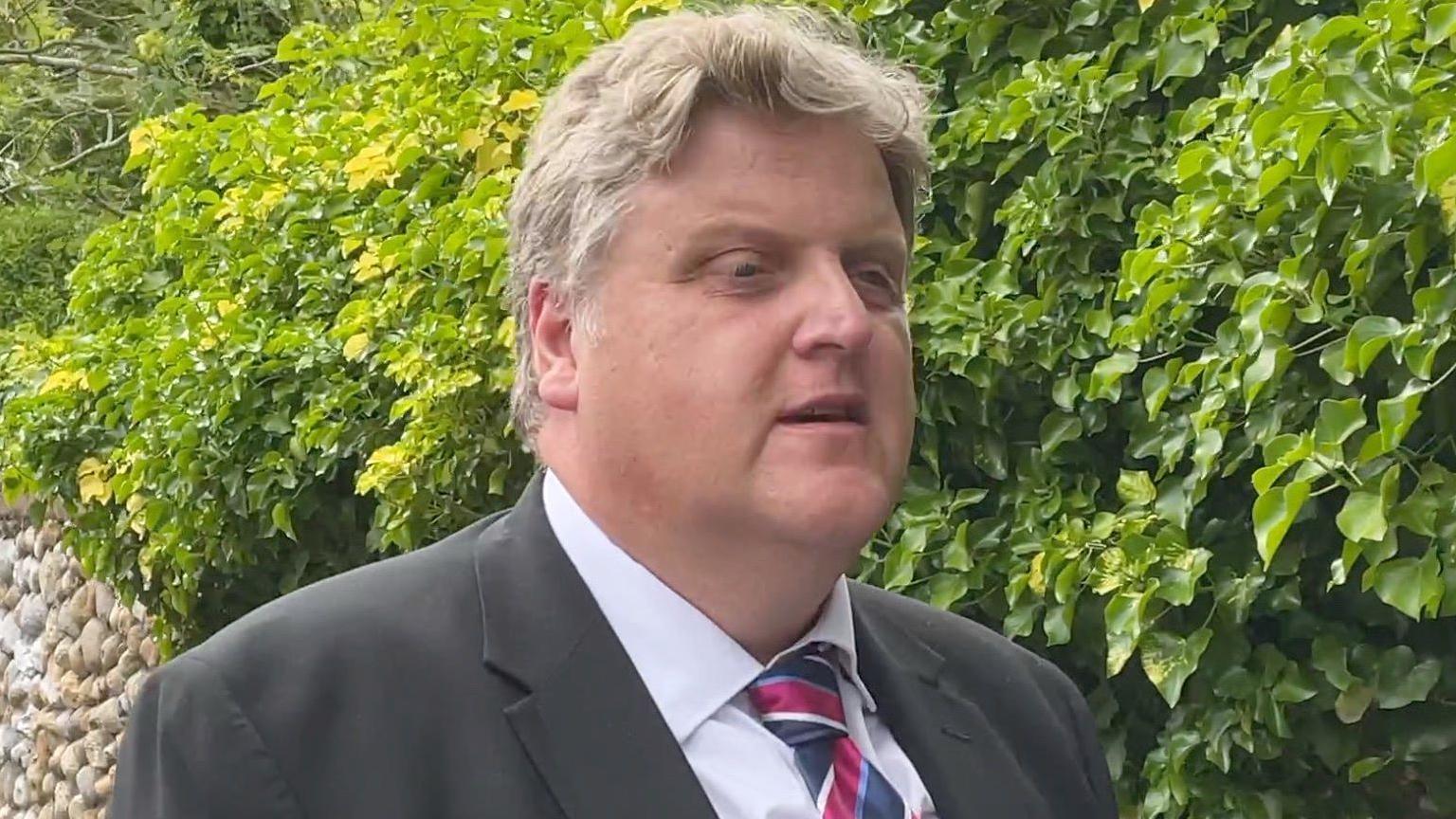 Gregory Hill, a middle-aged man wearing a jacket and tie, pictured at court