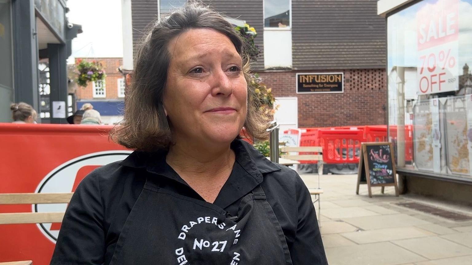 Samantha Morgan standing in a street with plastic fencing behind her shielding roadworks