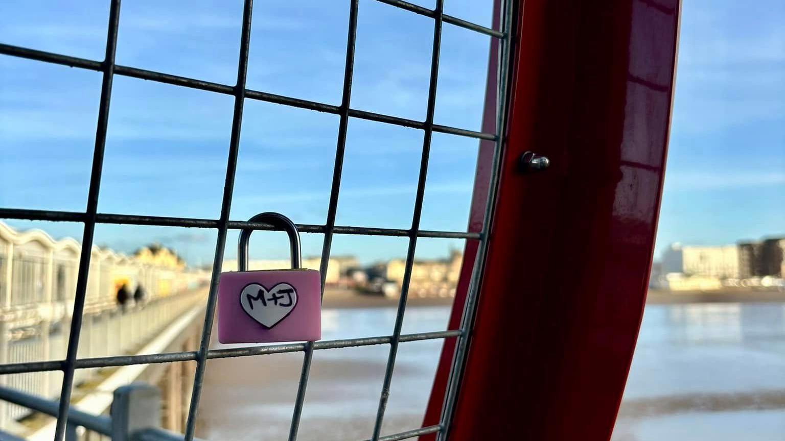 A love lock on a fence on The Grand Pier