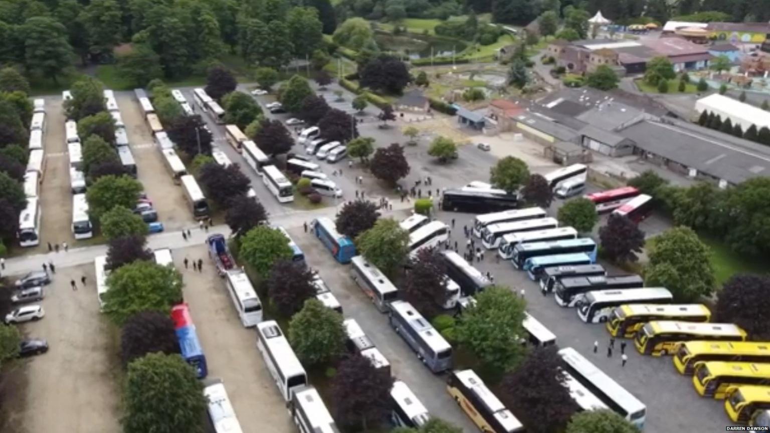 drone shot of coaches in car park