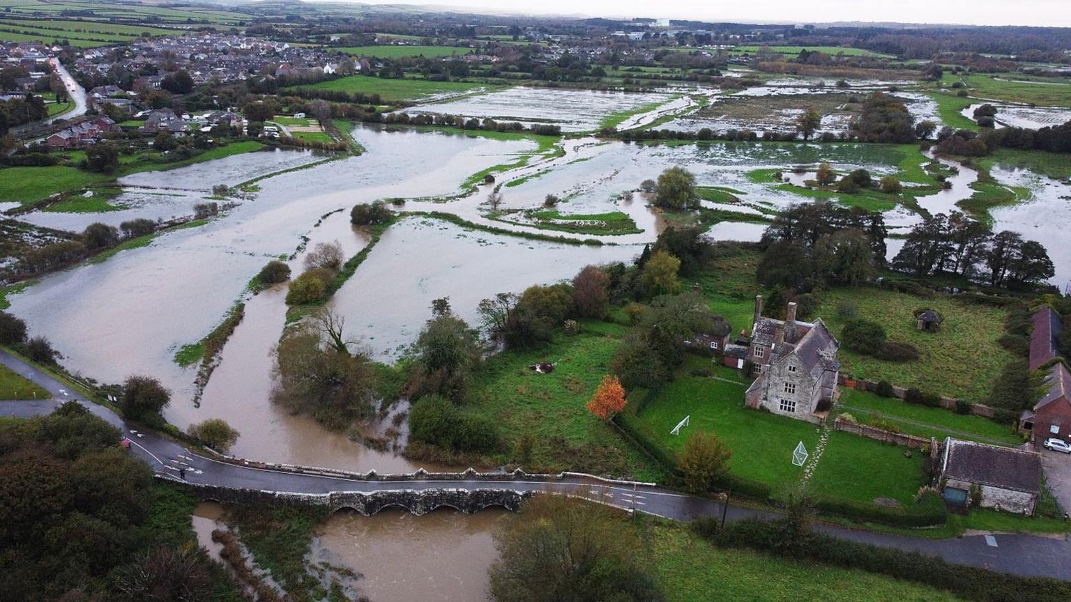 Flooding at Wool in Dorset showing Woolbridge and Woolbridge Manor.