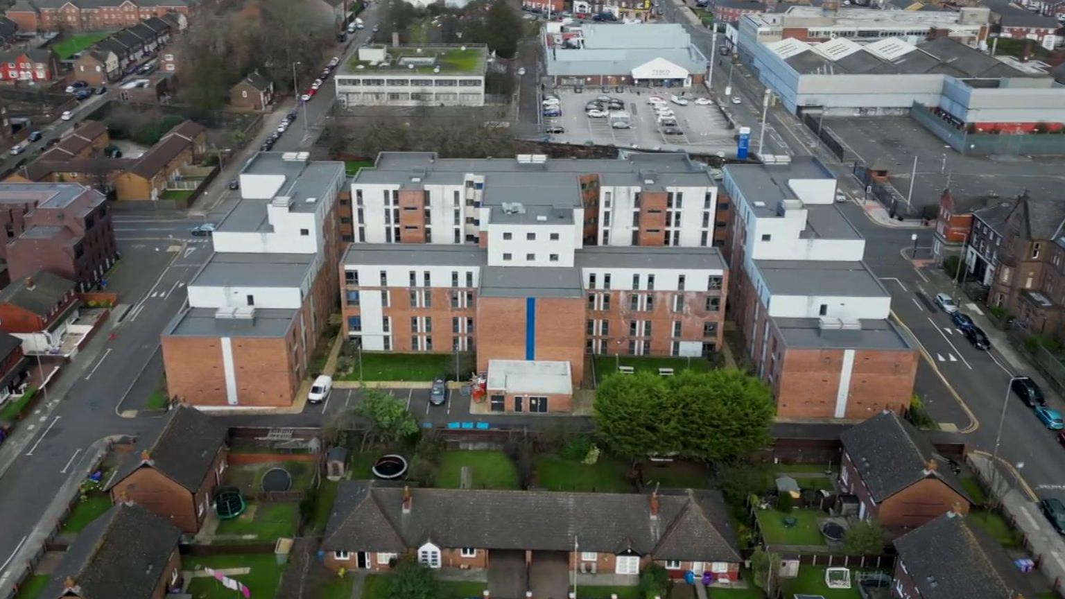 The Queensland Place student complex in Liverpool as seen from drone footage. It is a five-storey block built in among residential and industrial units in the middle of the Kensington area of Liverpool.