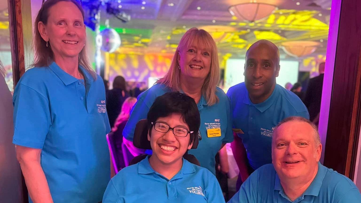 Group of hospital volunteers in their blue uniform