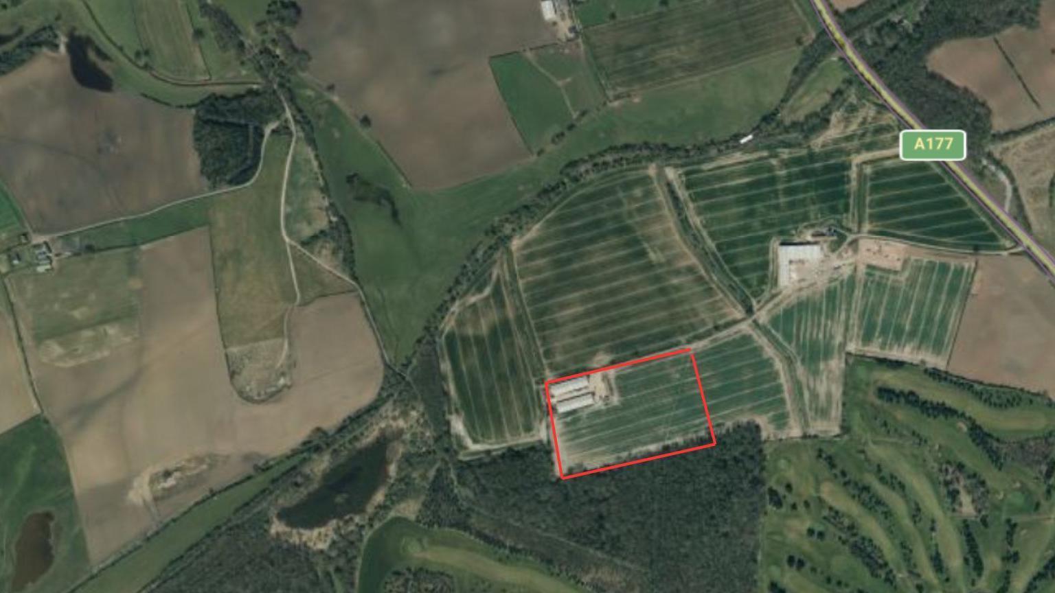 An aerial shot of the plot of land where the plant will be be built. The A177 road is nearby. Among the green fields is a red square demarking where it will be developed. 