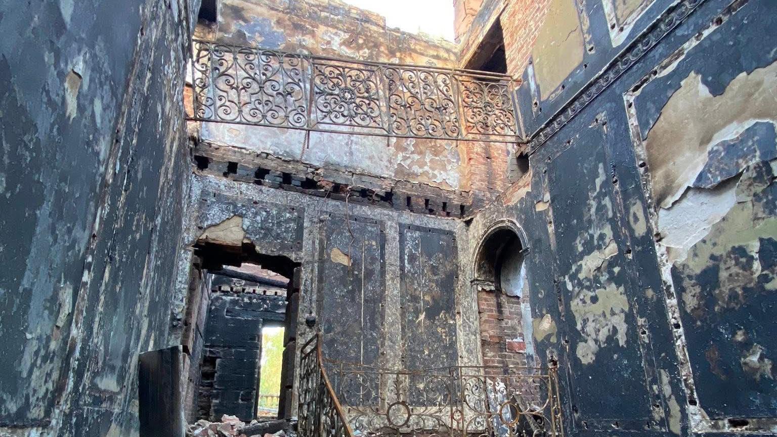A shot of the completely destroyed interior of Woolton Hall after a major fire there on August 19. The sky can be seen where the roof used to be.