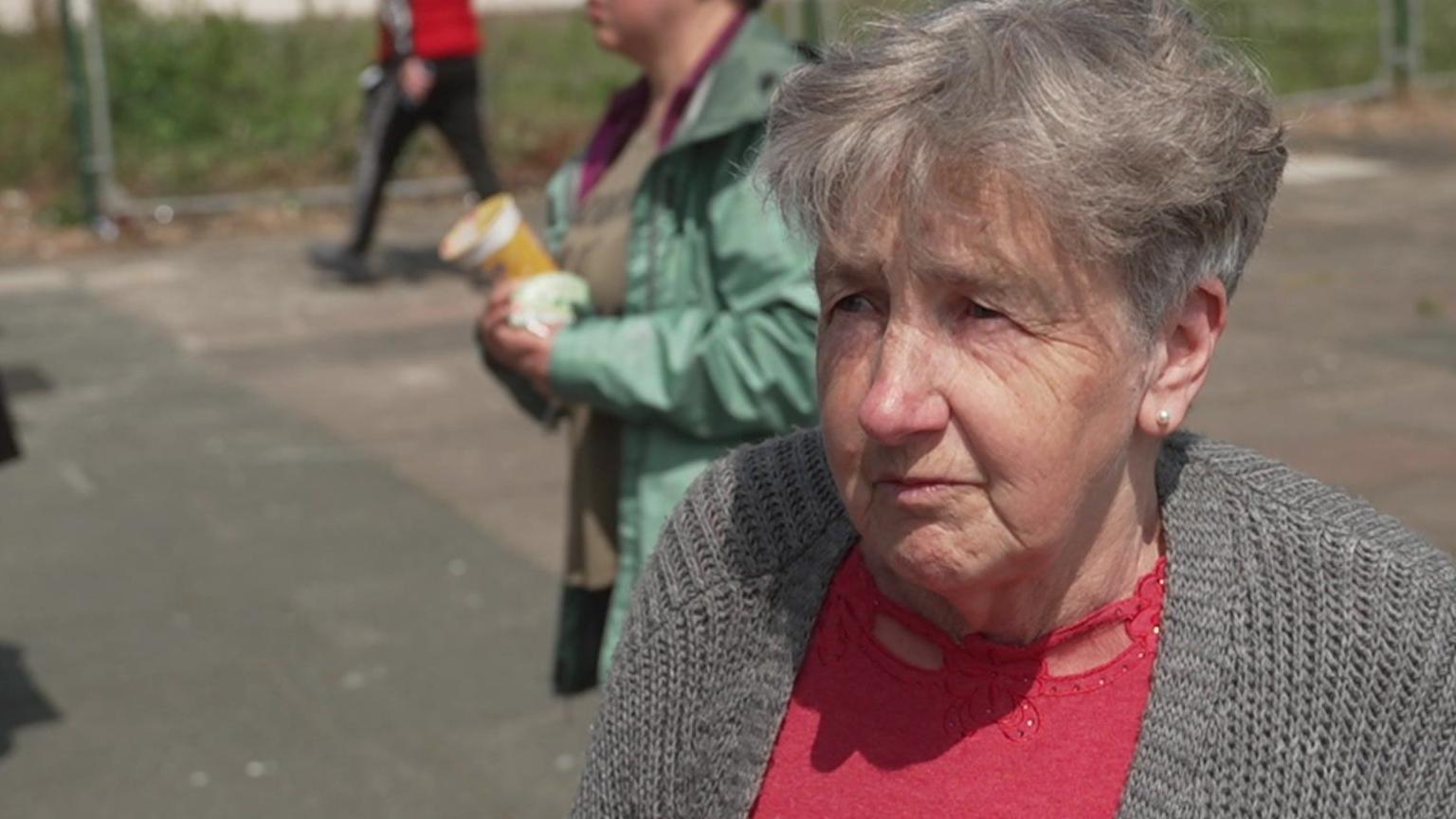 Yvonne wearing a red top and grey cardigan