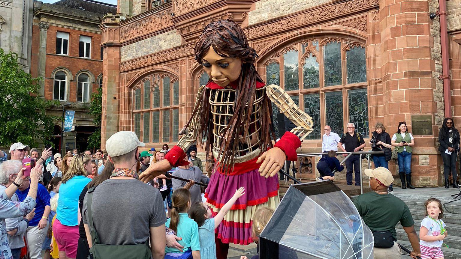 Little Amal puppet in Derry's Guildhall square