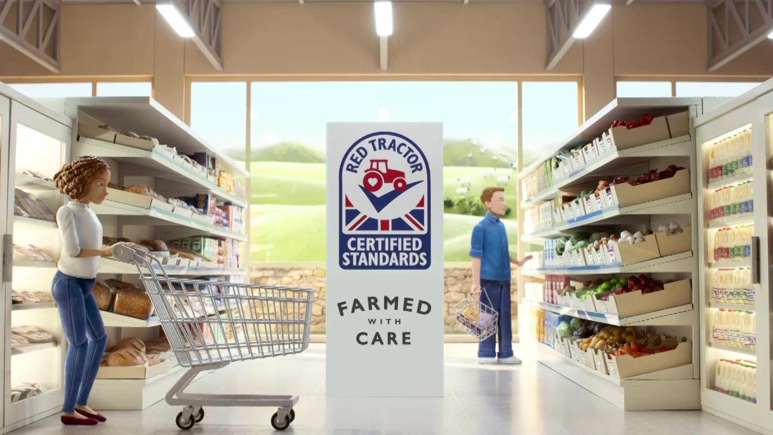 A screenshot of the Red Tractor advert showing an animation of a woman pushing a trolley through a supermarket, in the middle of the aisle is the Red Tractor logo underneath it says "certified standards" and "farmed with care". To the right of the image a man looks at produce on the shelves.