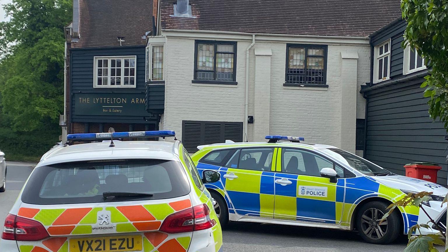 Police cars parked outside the pub