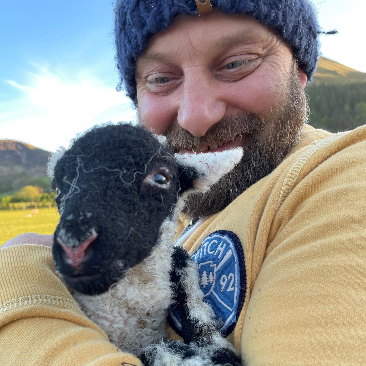 Jaroslaw Ringart holding a lamb