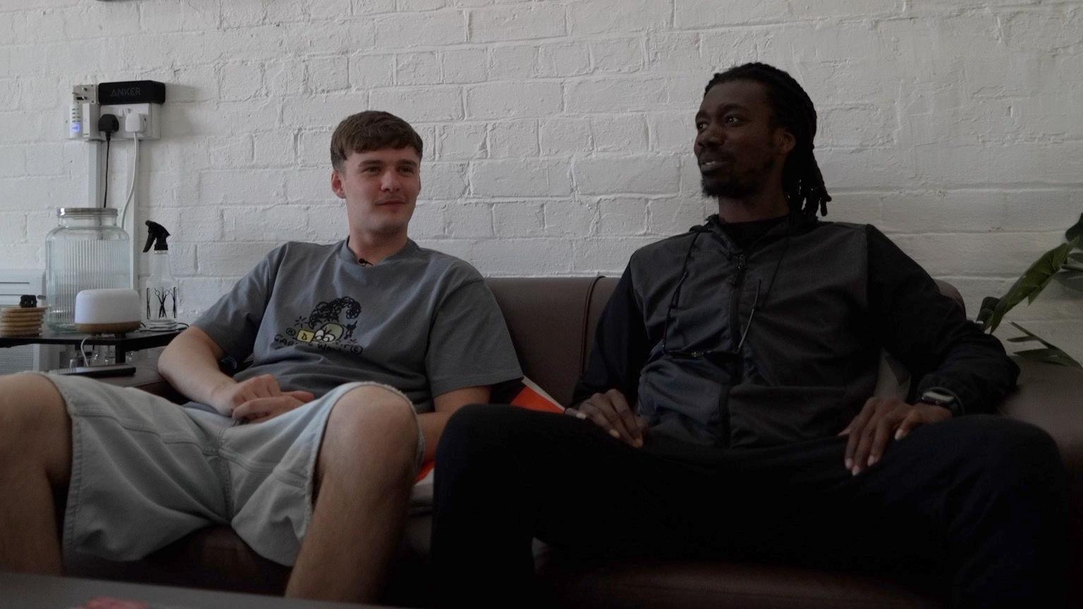 Jack and Dom sat together on a sofa, both wearing casual clothing, talking about their vision for the documentary.