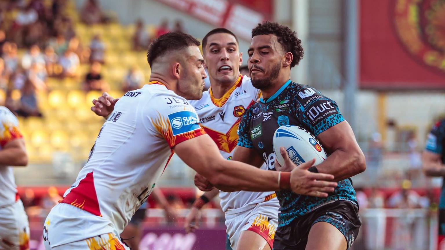 Darnell McIntosh of Leigh is tackled by Nick Cotric of Catalans