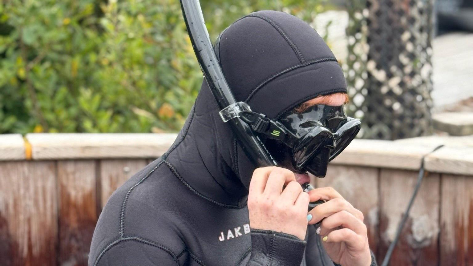 Kirsty Muir in underwater swimming outfit, including a black mask and snorkel