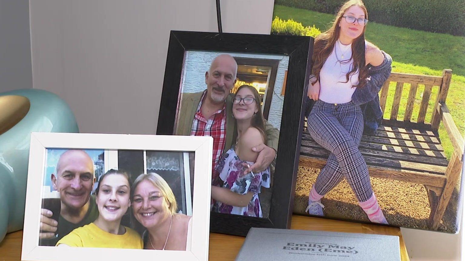 Photos on a mantlepiece of a young girl with an older man and woman