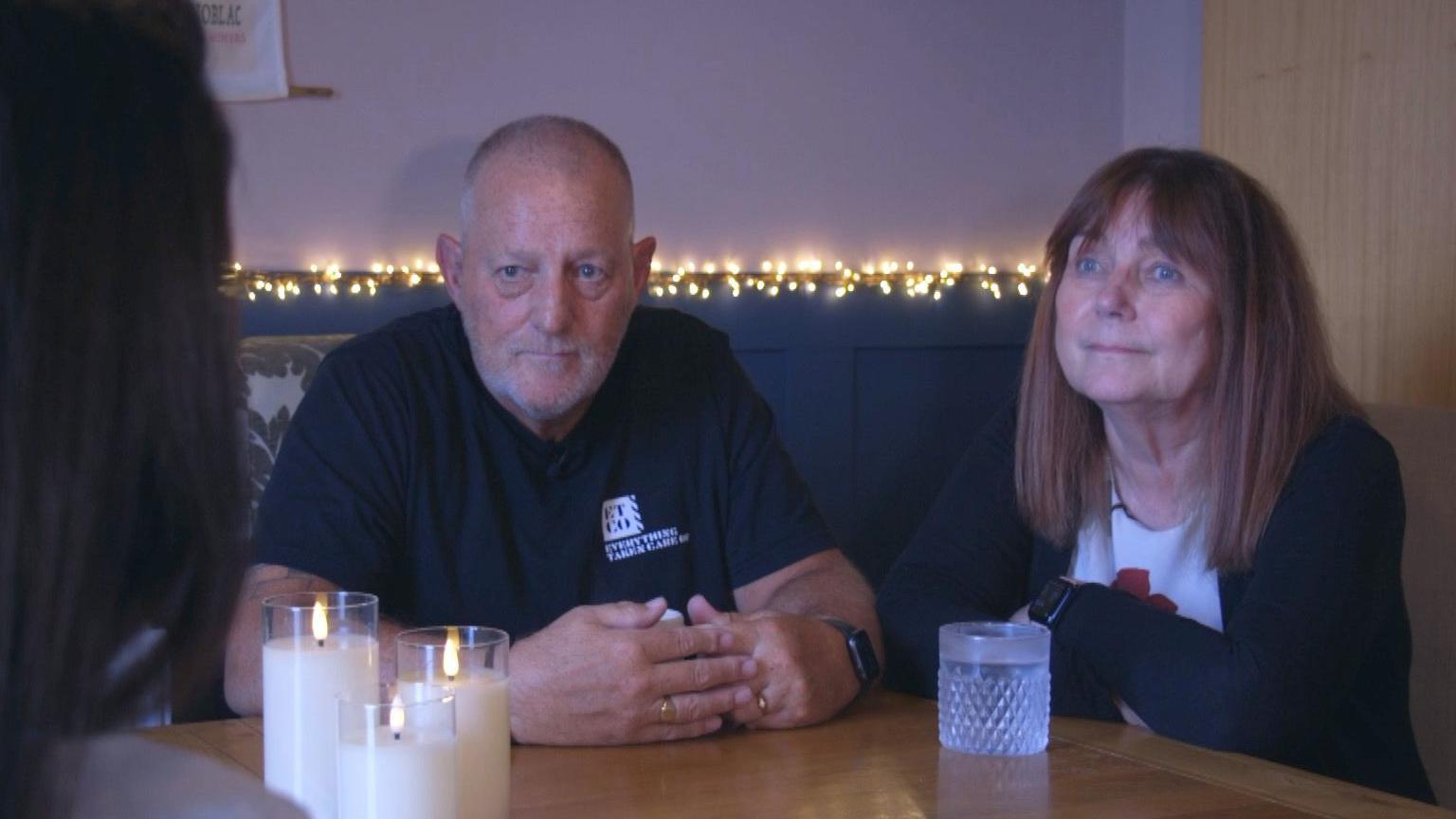 Grandparents Julie and Derek sat at a table