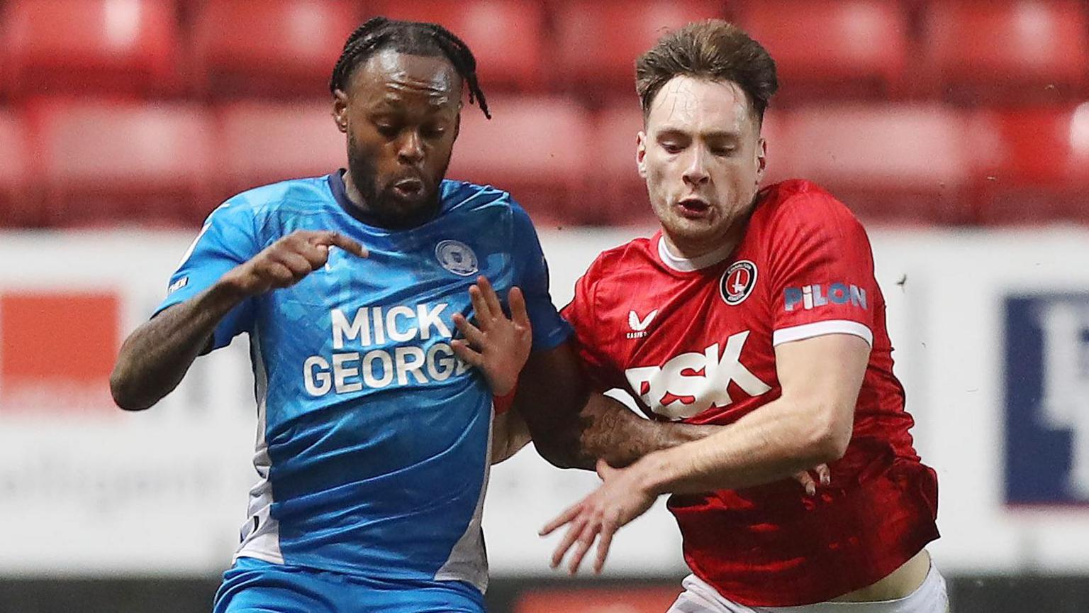 Ricky-Jade Jones of Peterborough United battles with Josh Edwards of Charlton Athletic 