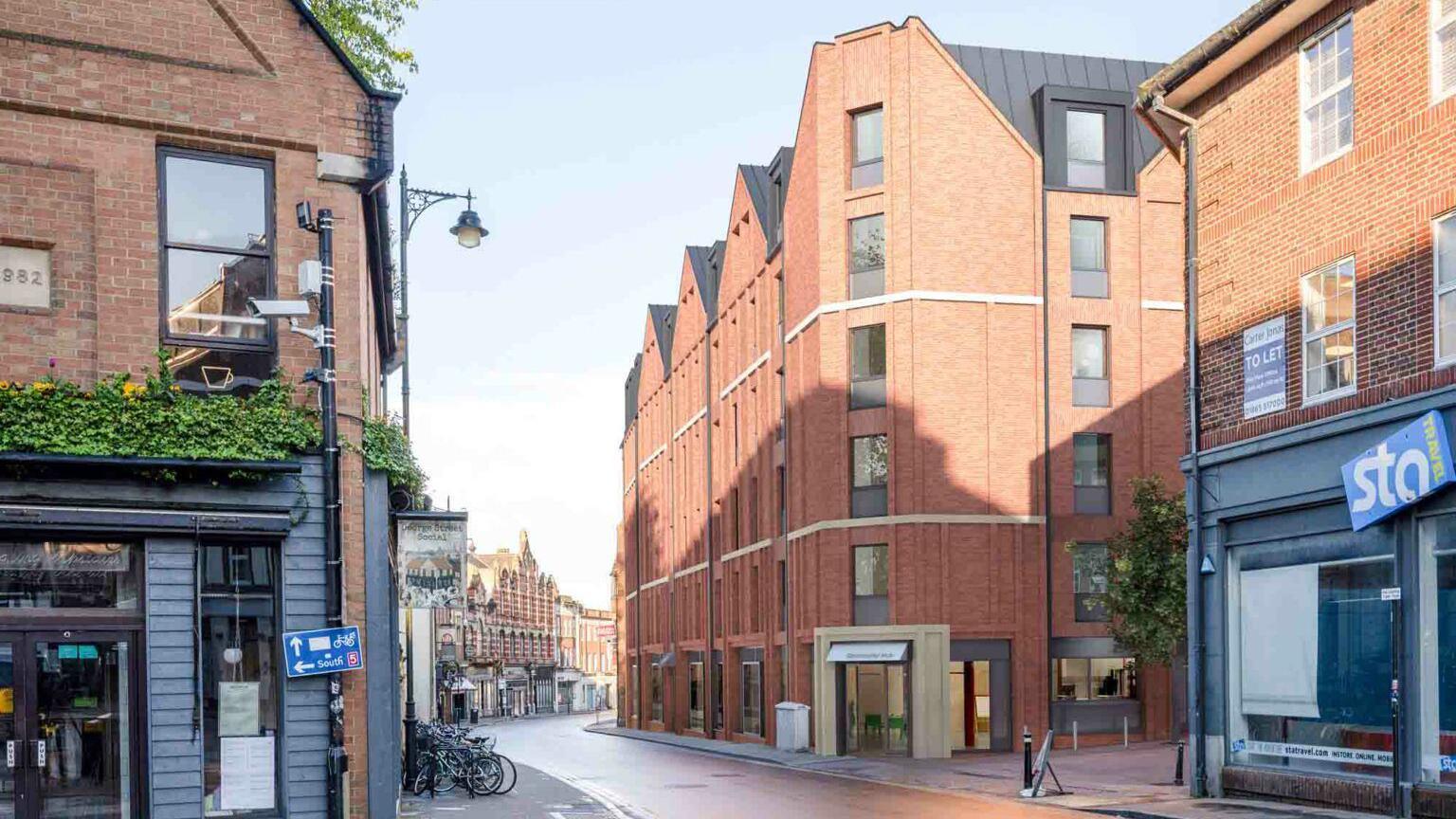 The design of the new building from George Street, showing a building taller than the current one, with triangular-shaped grey rooftop. The entrance of the new hotel is facing George Street