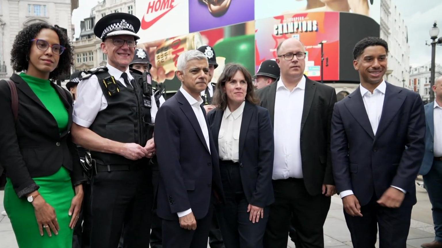 Mark Rowley and Sadiq Khan with members of their team in Piccadilly Circus