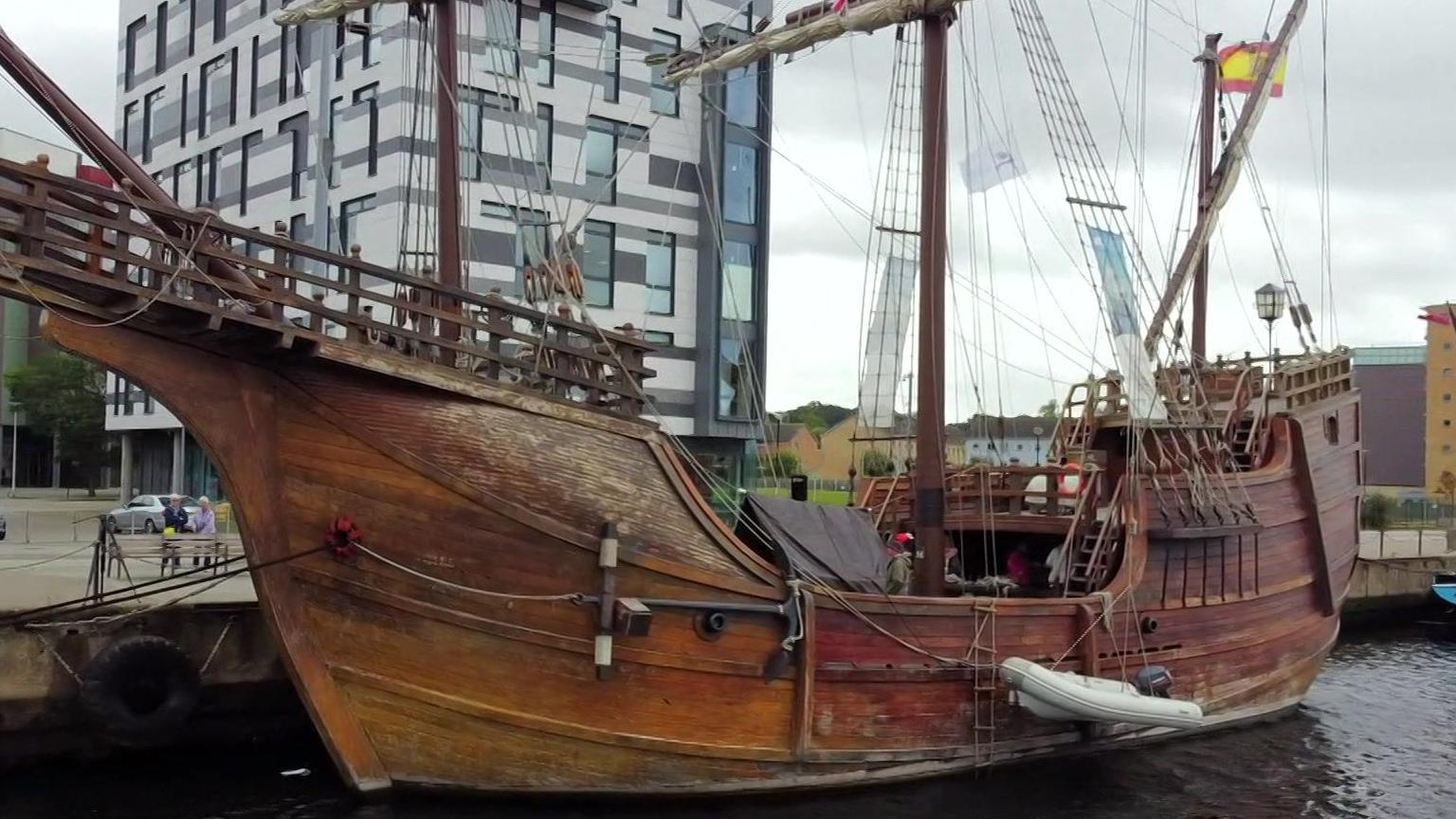 A drone image of the ship from its other side above the water. 