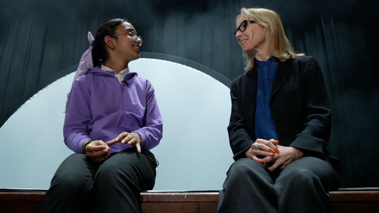 First time performer Aiza, who is 10 years old -- wearing lilac top, dark trousers and glasses excitedly told Katie Razzall, in black jacket, that taking part in the project made her want to do so again