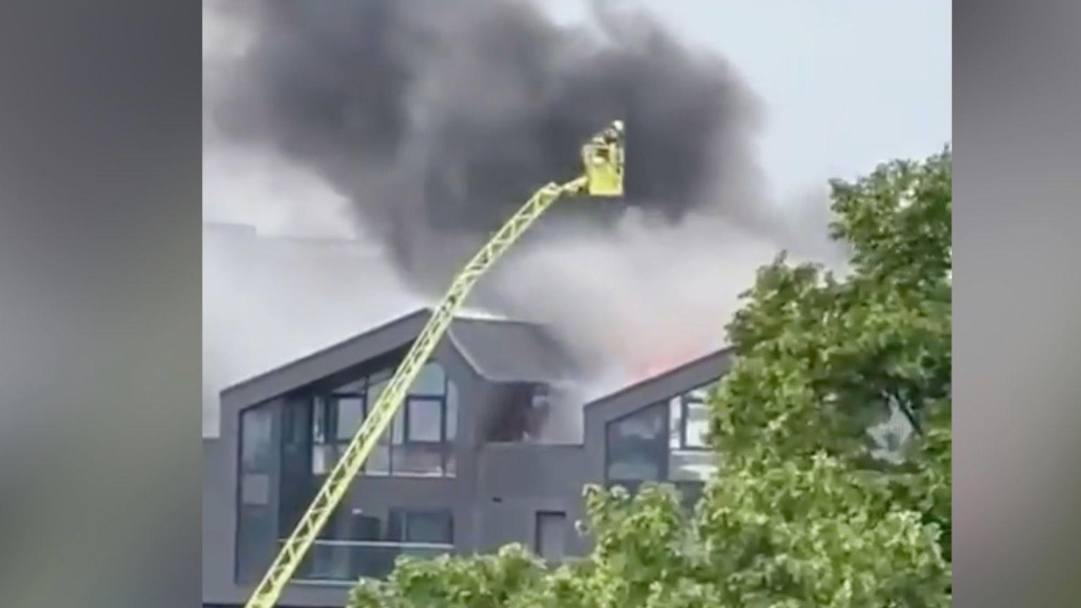 Smoke seen pouring from the block of flats b