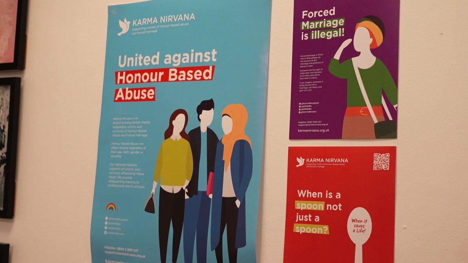 A wall with three posters. One is blue with coloured silhouttes of three people on it and the headline reads United Against Honour Based Violence. On the top right, a purple poster reads Forced Marriage is illegal and a red poster below it says when is a spoon not a spoon. The answer is written inside a white spoon silhoutte which says when it saves a life.
